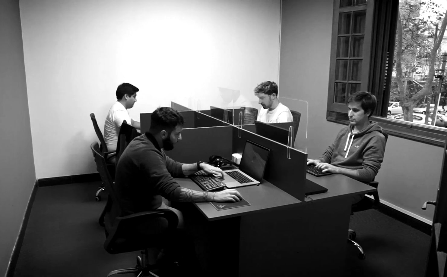 Four guys in a room working on their computers