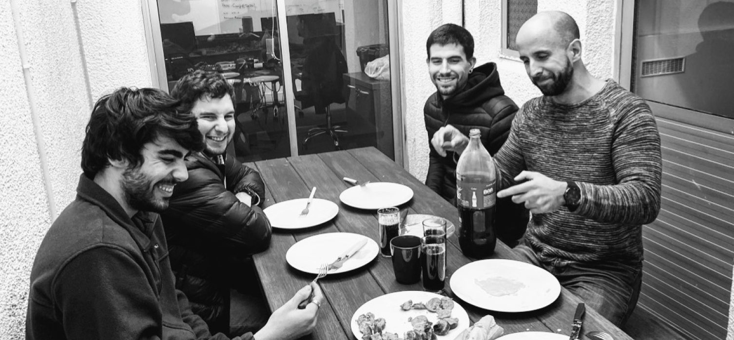 Four guys having lunch outdoors