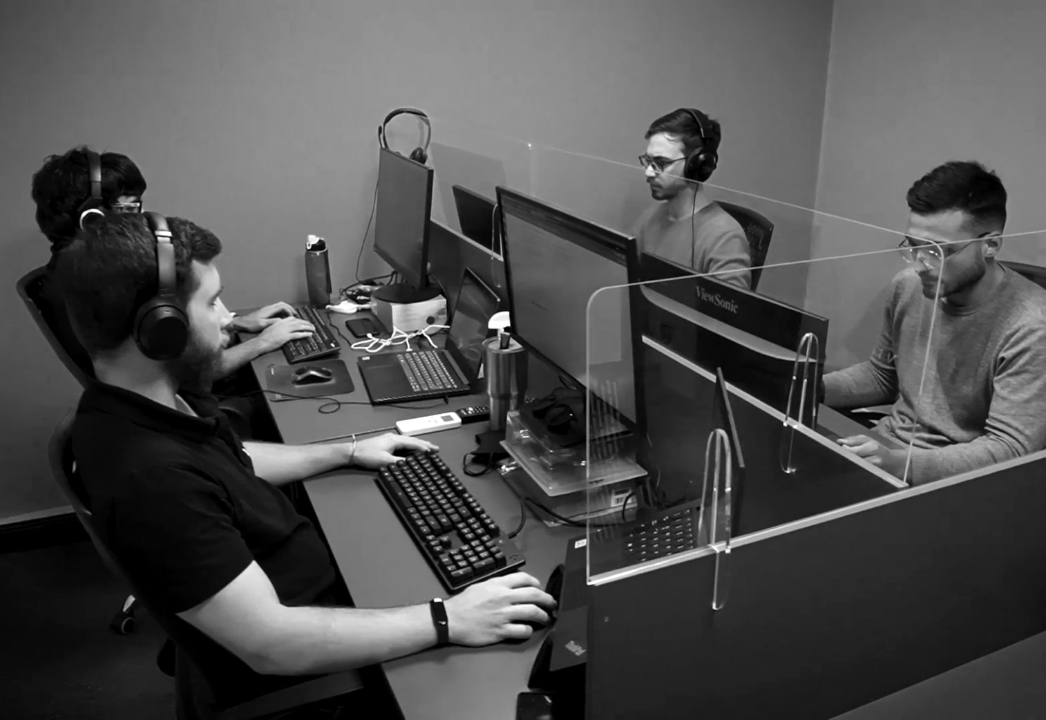 A room with four guys working on their computers